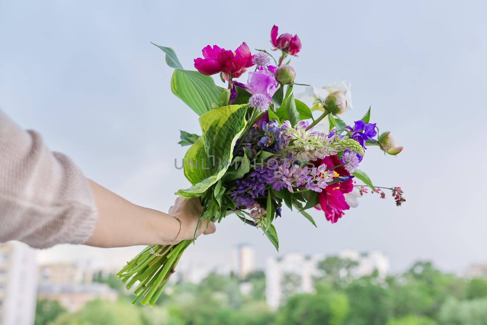 Close-up of bright bouquet of flowers in female hand by VH-studio