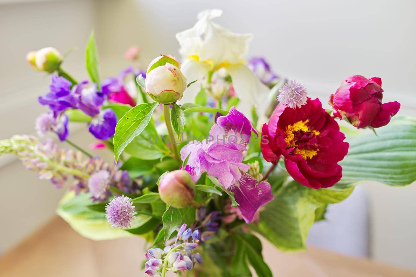 Abstract multicolored floral background texture, close-up flowers and buds peonies irises lupine in defocus, season spring summer, natural beauty, background image