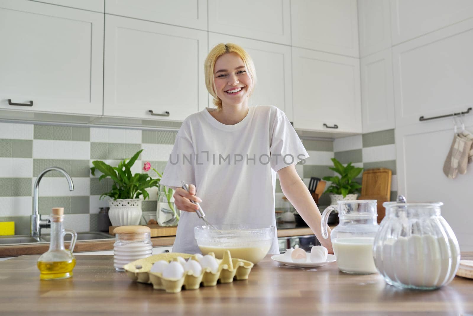 Female teenager preparing food at home, making pancakes by VH-studio