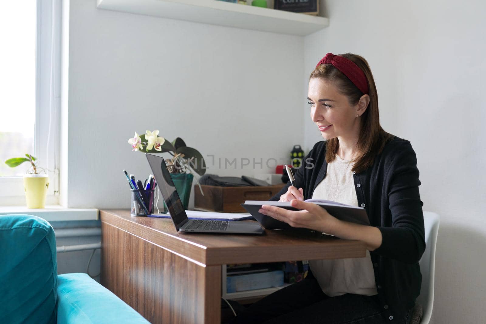 Businesswoman, female teacher working online at home with laptop using video call. Woman freelancer, working remotely, teaching individually. Online technology, business, education concept