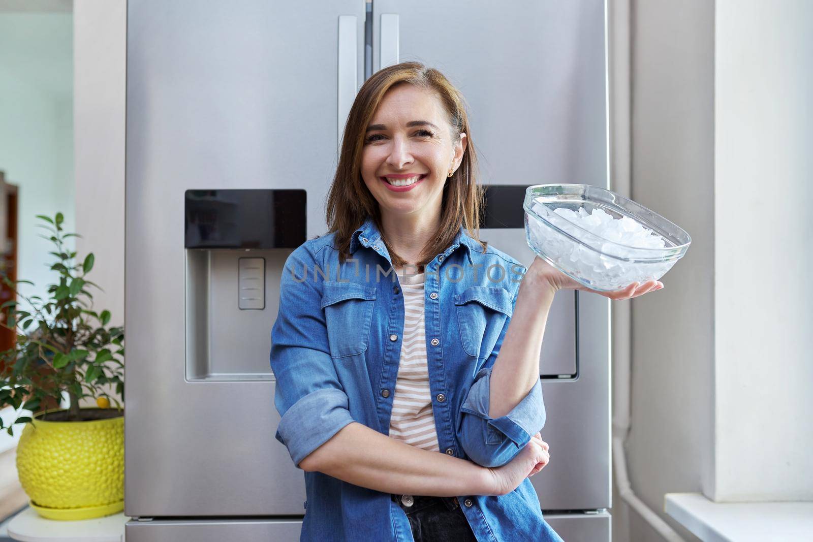 Woman with bowl with ice cubes for cooling food by VH-studio