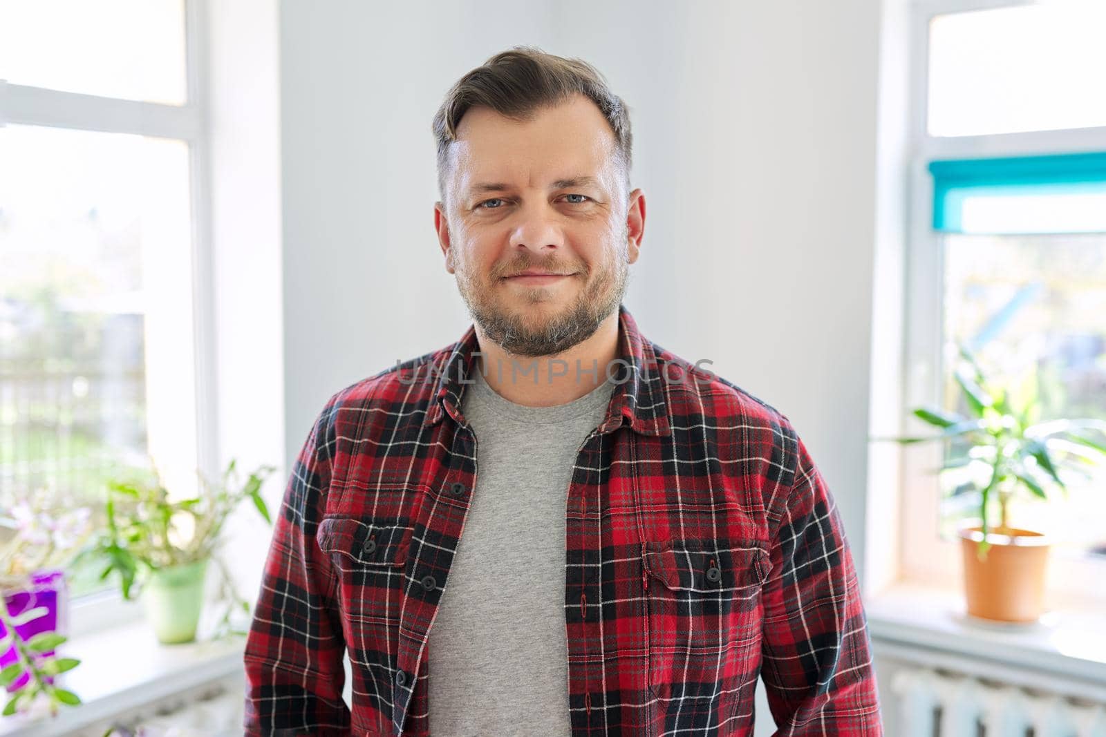 Portrait of 40 years old man, smiling male in plaid casual shirt looking at camera by VH-studio