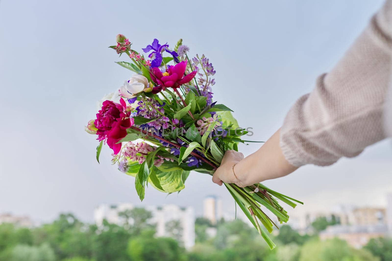 Close-up of bright bouquet of flowers in female hand by VH-studio