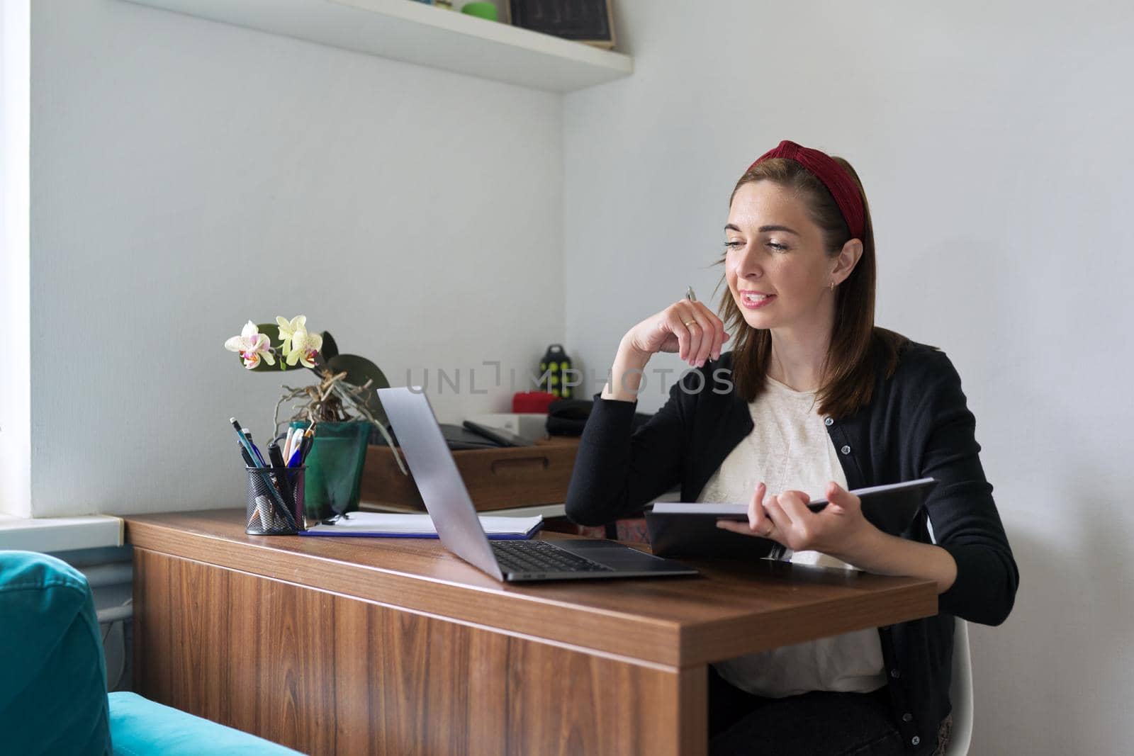 Businesswoman, female teacher working online at home with laptop using video call. Woman freelancer, working remotely, teaching individually. Online technology, business, education concept