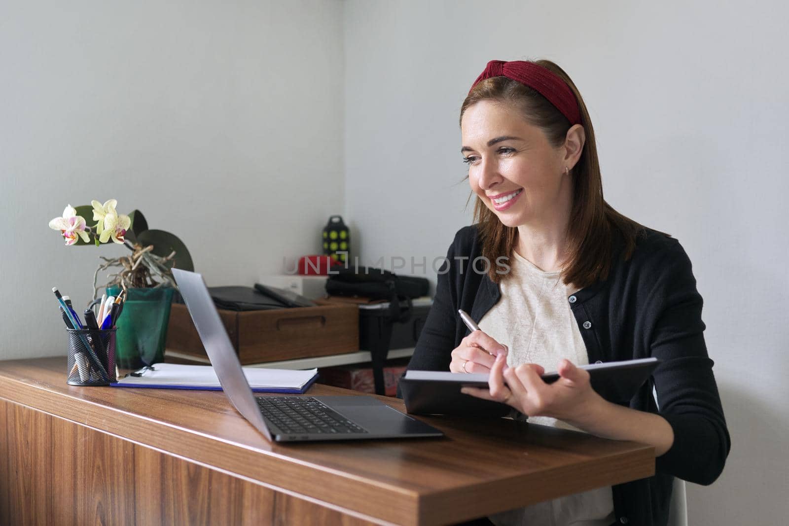 Businesswoman, female teacher working online at home with laptop using video call. Woman freelancer, working remotely, teaching individually. Online technology, business, education concept