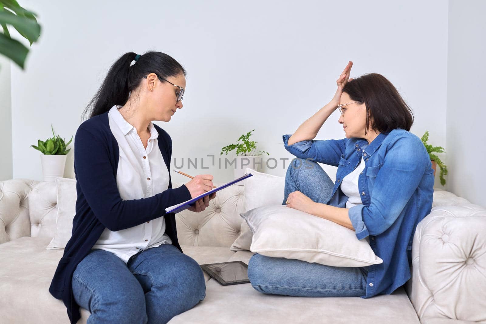 Mature woman at meeting with psychologist, therapist, counselor. Professional help, mental health of middle-aged people, social difficulties