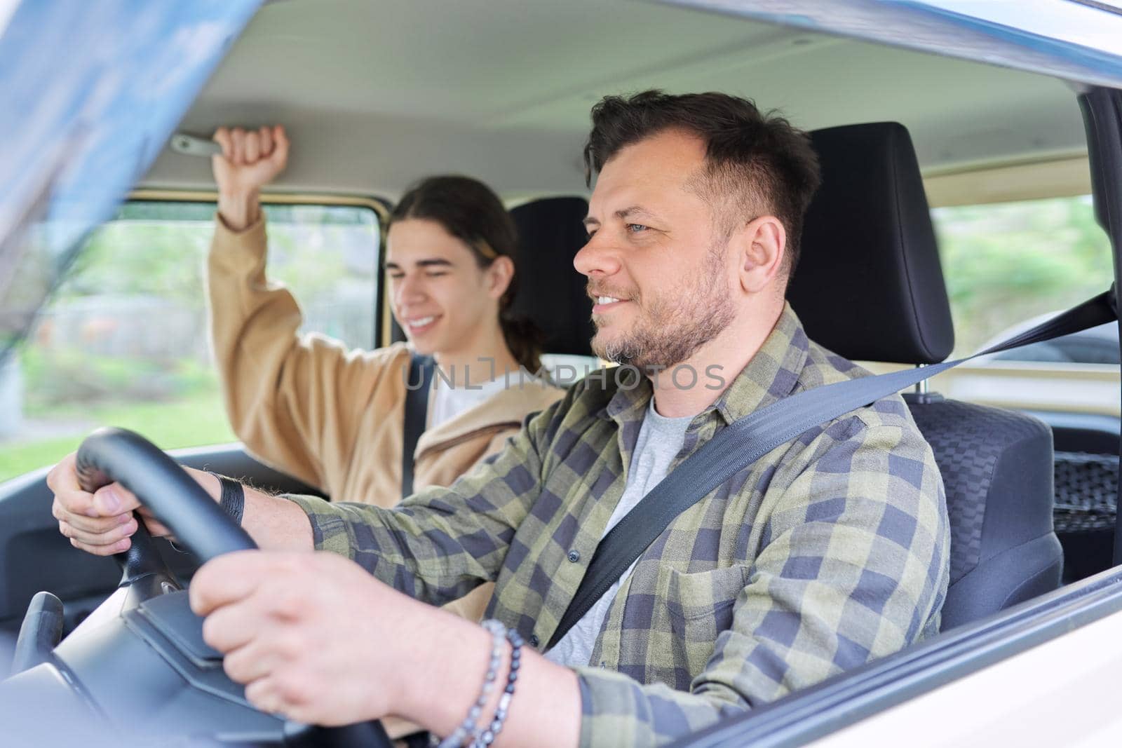 Portrait of father and teenage son together, man driving car by VH-studio