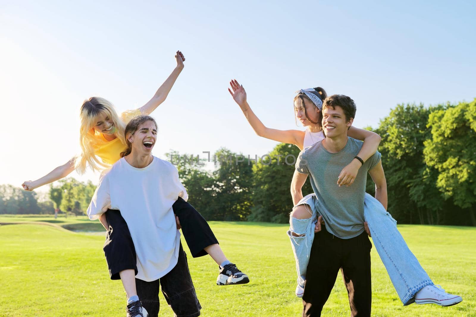 Happy group of teenagers having fun outdoors by VH-studio