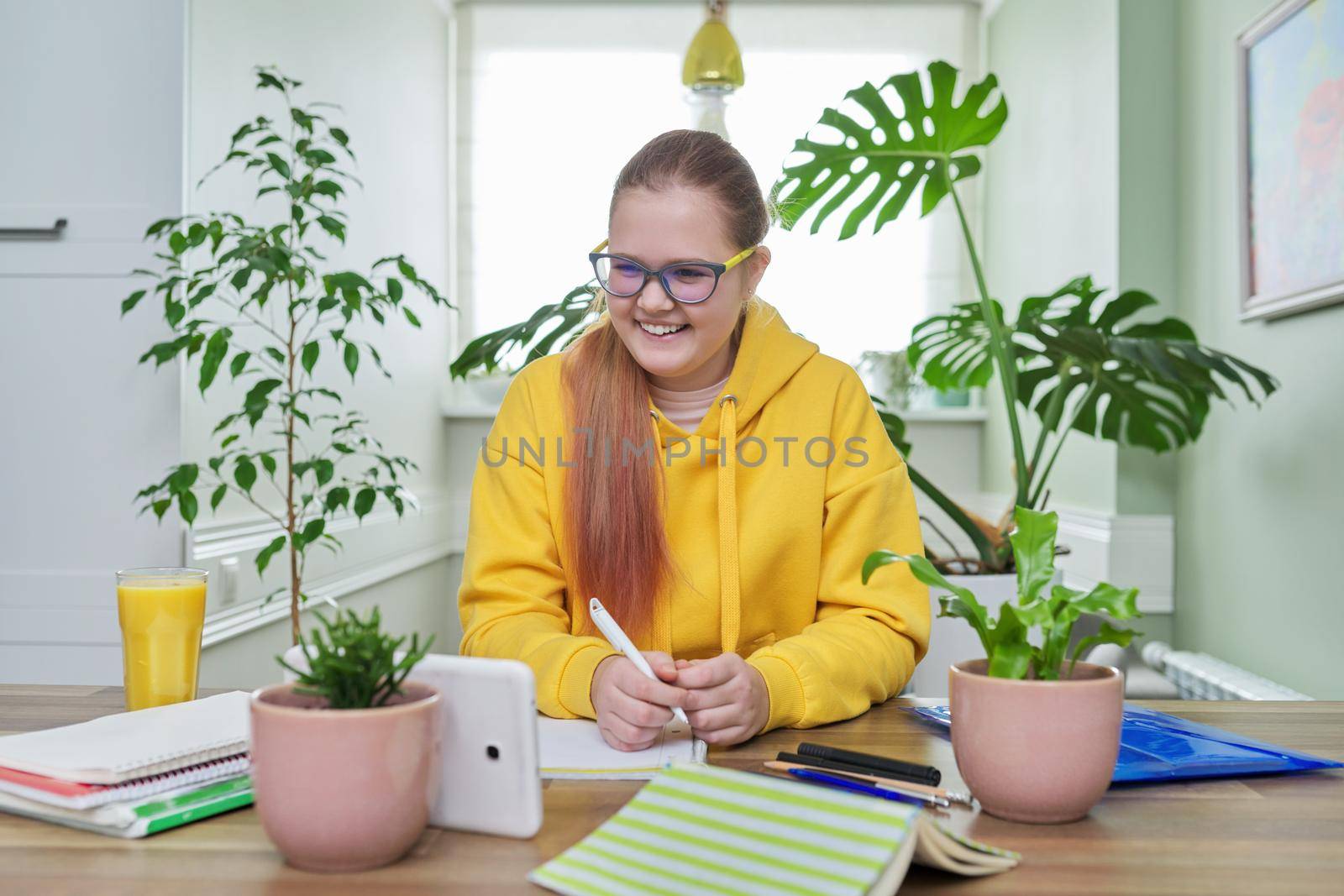 School online learning, e-education, teenage girl looking at screen of digital tablet by VH-studio