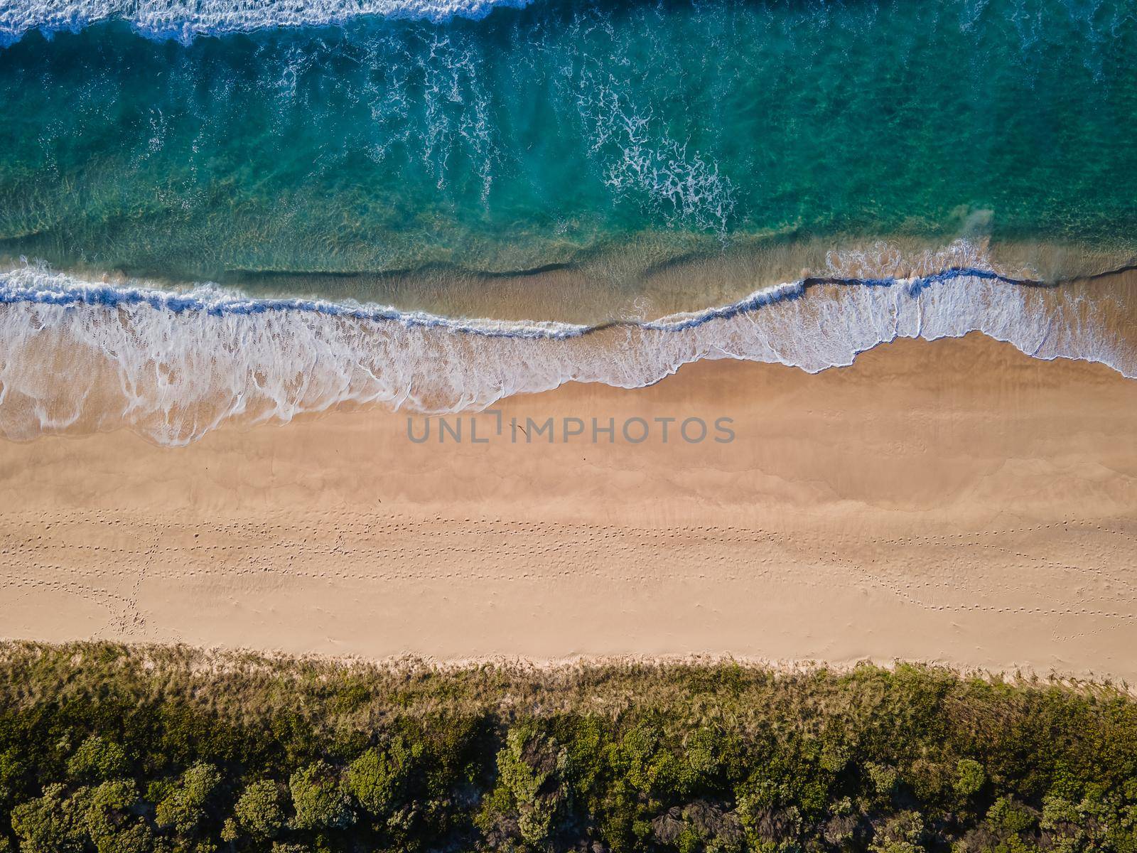 Aerial photo of a beach and trees in Ulladulla, NSW, Australia by braydenstanfordphoto