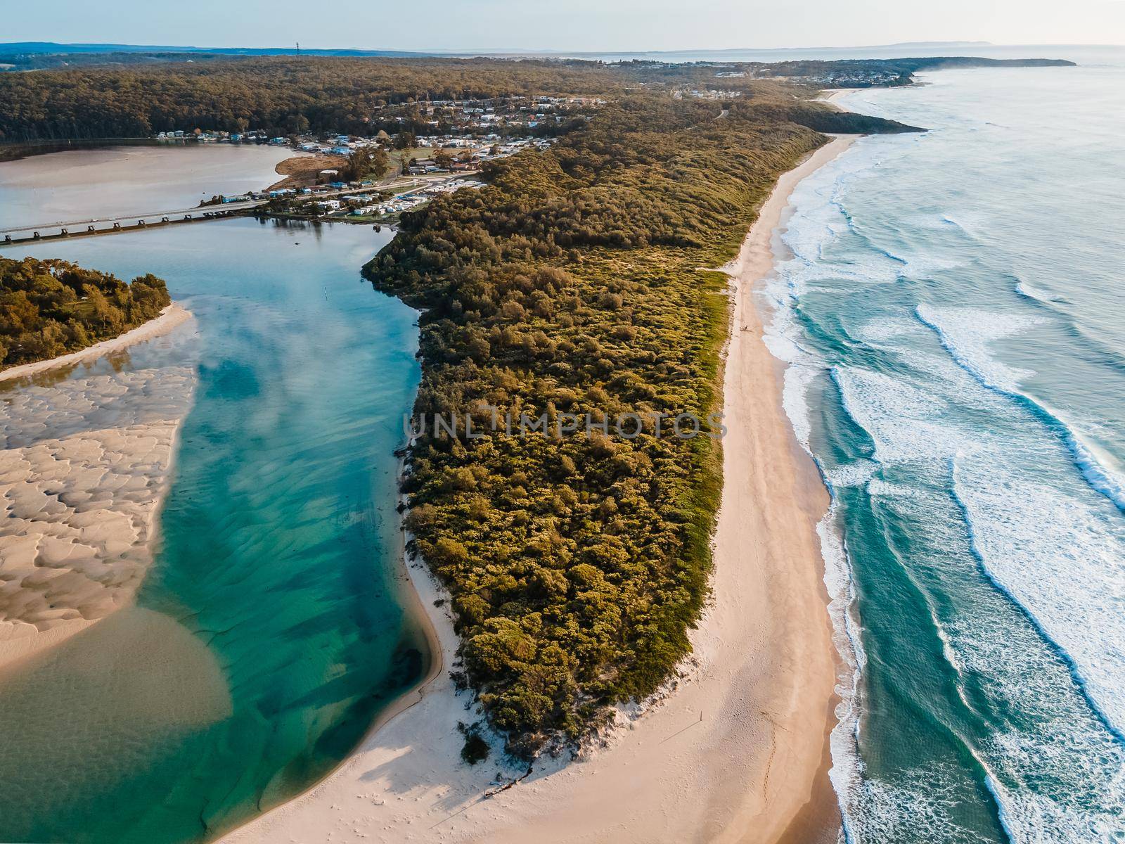 Aerial photo of a beach and trees in Ulladulla, NSW, Australia. High quality photo