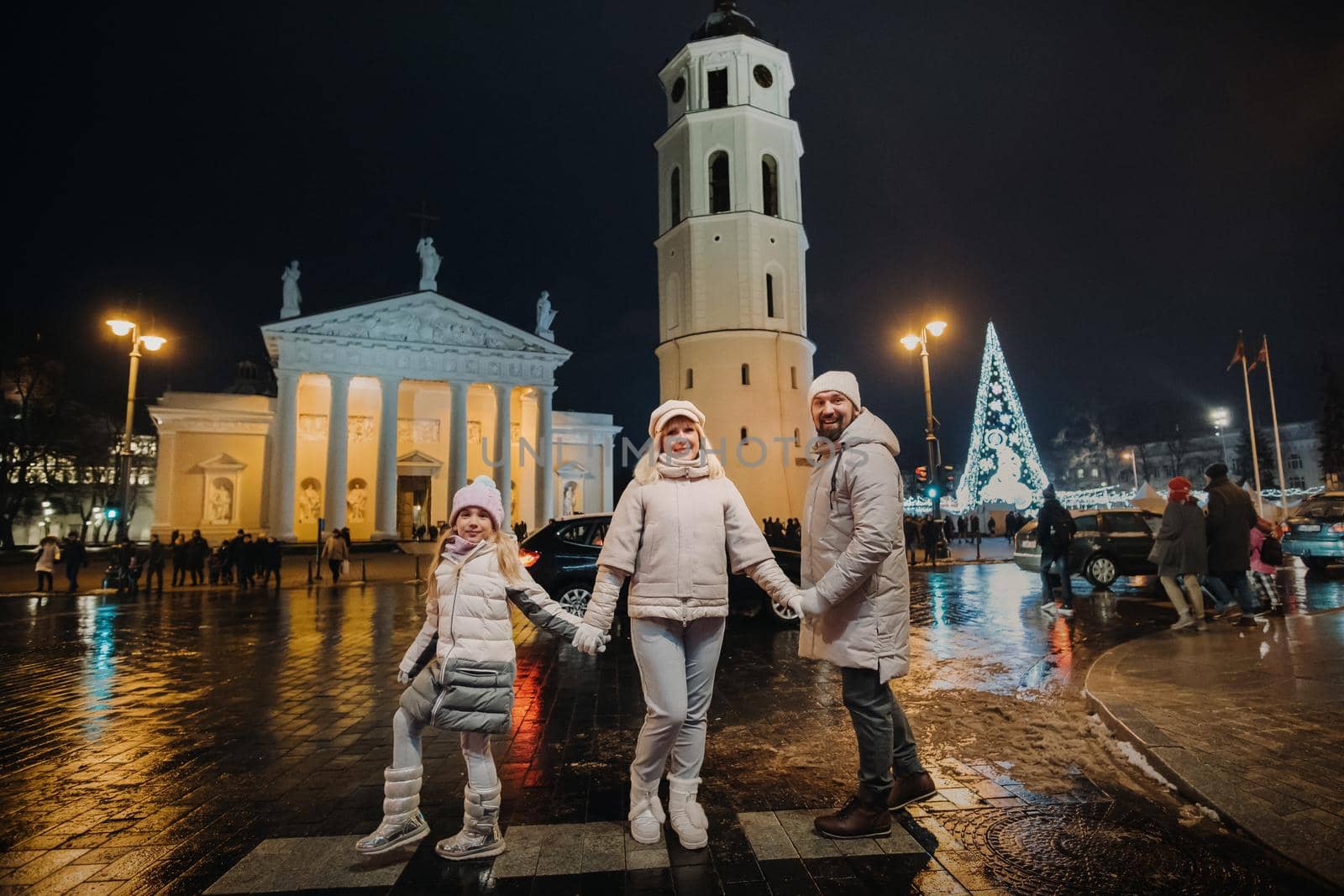 A family walks around the New Year's city of Vilnius.Lithuania by Lobachad