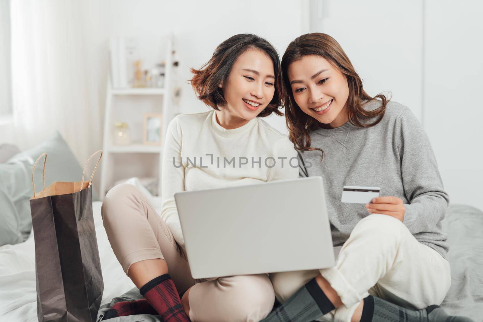  Beautiful female friendship enjoy weekend activity lifestyle with technology at home. by makidotvn