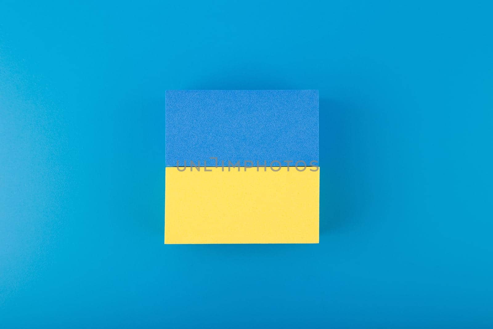 Creative flat lay with national flag of Ukraine on dark blue background by Senorina_Irina