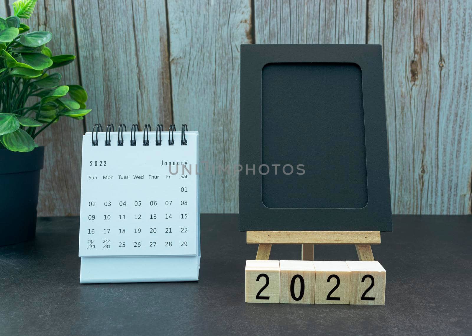 January 2022 white calendar with black notepad and with wooden block - New year concept