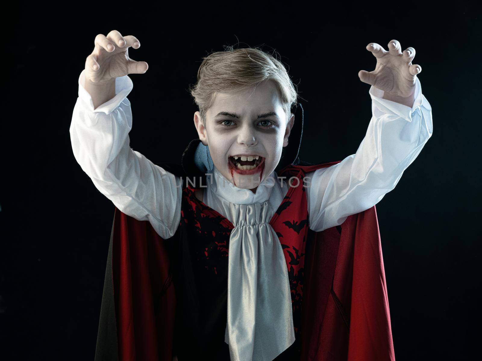 Boy in Halloween vampire makeup costume by Yellowj
