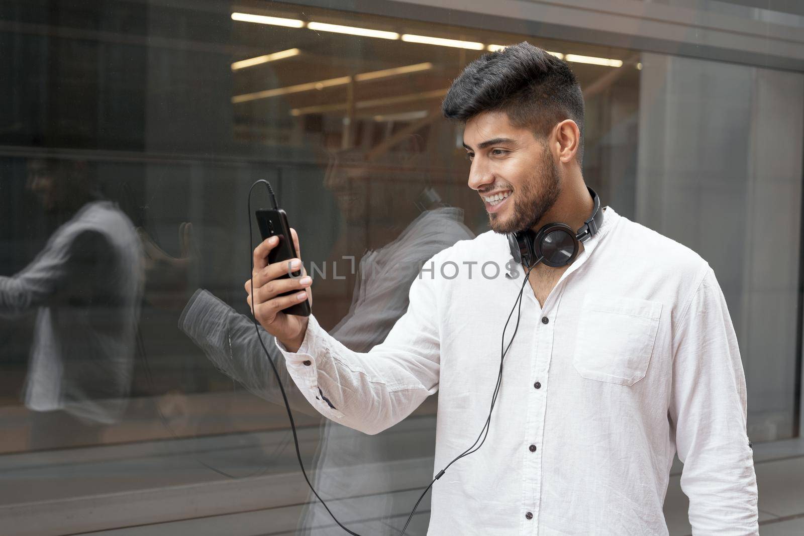 Portrait of a young man enjoying music outdoors. High quality photo