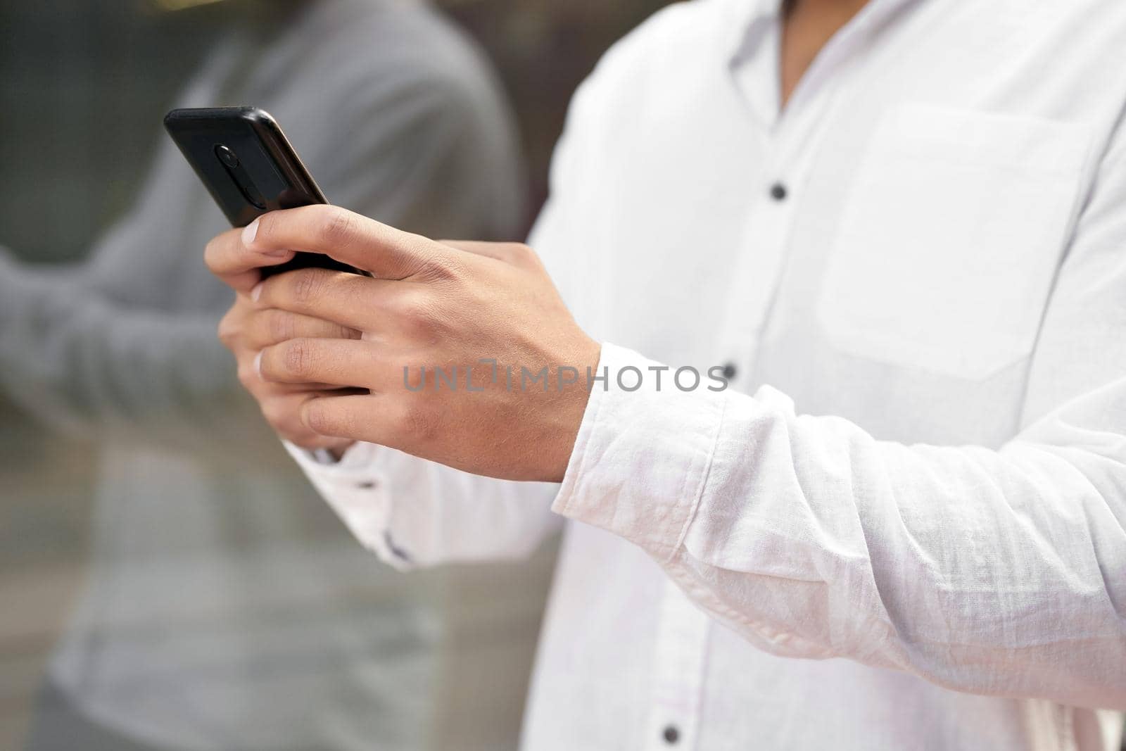 Close up Man texting on cell phone. by HERRAEZ