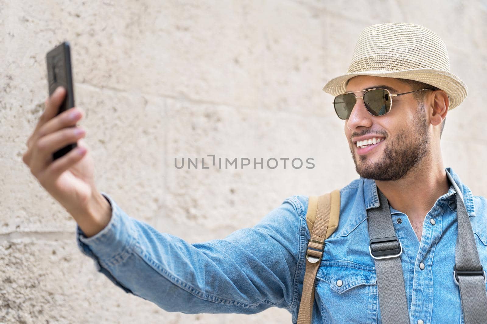 Happy tourist taking selfie in old city. High quality photo.