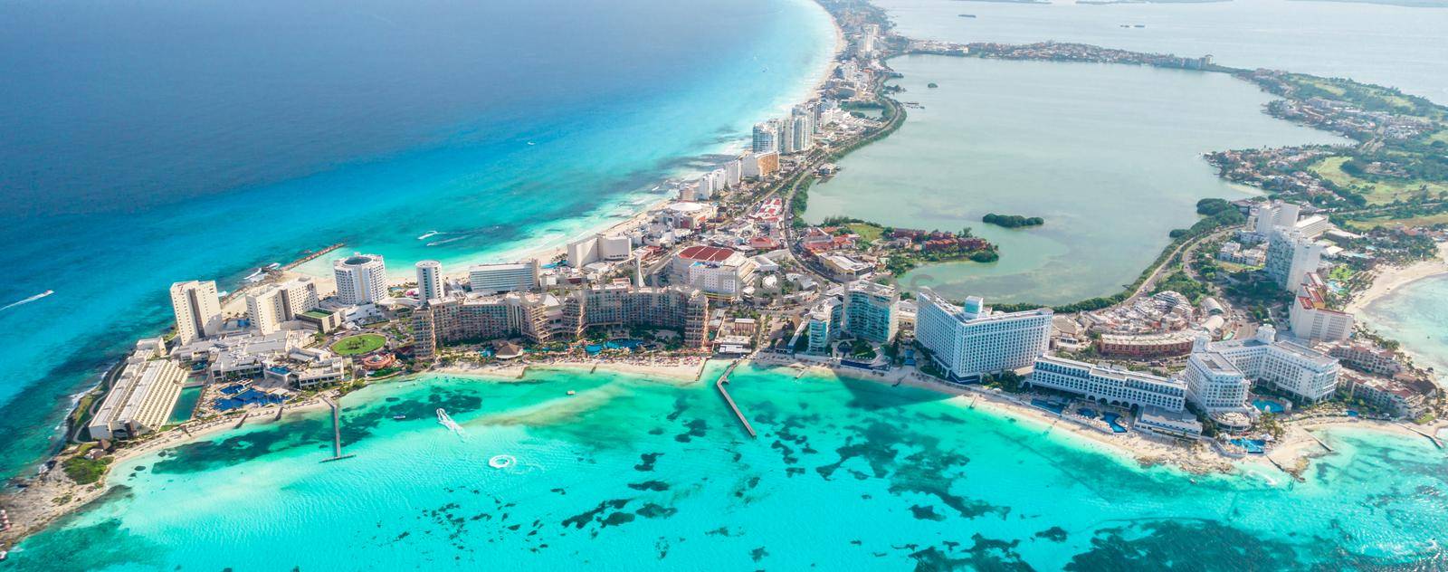 Aerial panoramic view of Cancun beach and city hotel zone in Mexico. Caribbean coast landscape of Mexican resort with beach Playa Caracol and Kukulcan road. Riviera Maya in Quintana roo region on Yucatan Peninsula by Mariakray