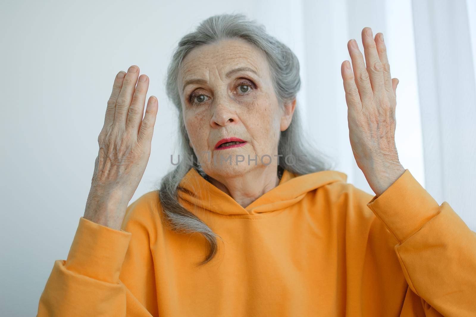 Closeup portrait of angry upset senior mature woman talking with someone and looking at the camera. Negative emotion, facial expression, scandal.