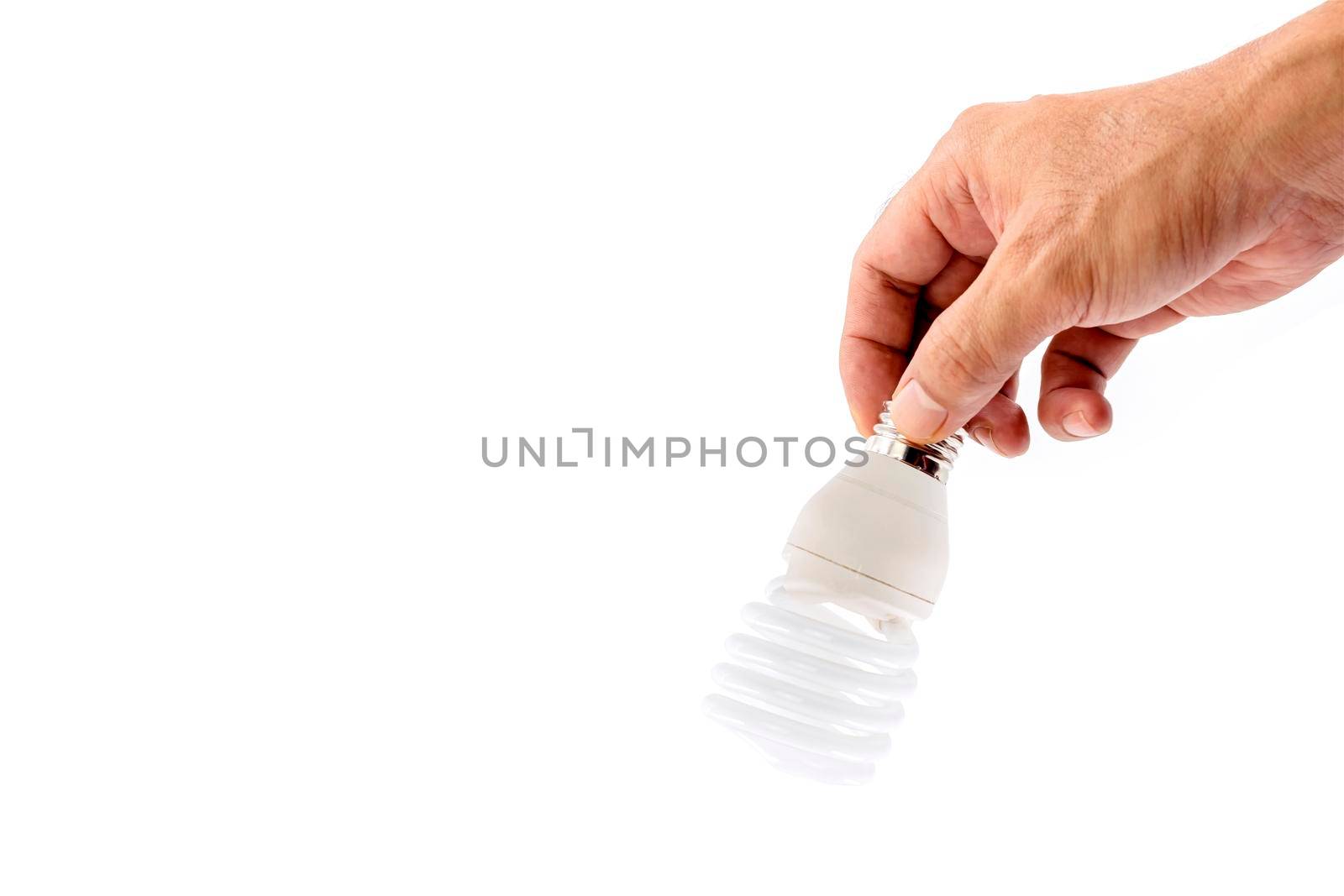 Human hand holding fluorescent light bulb isolated on white background.
