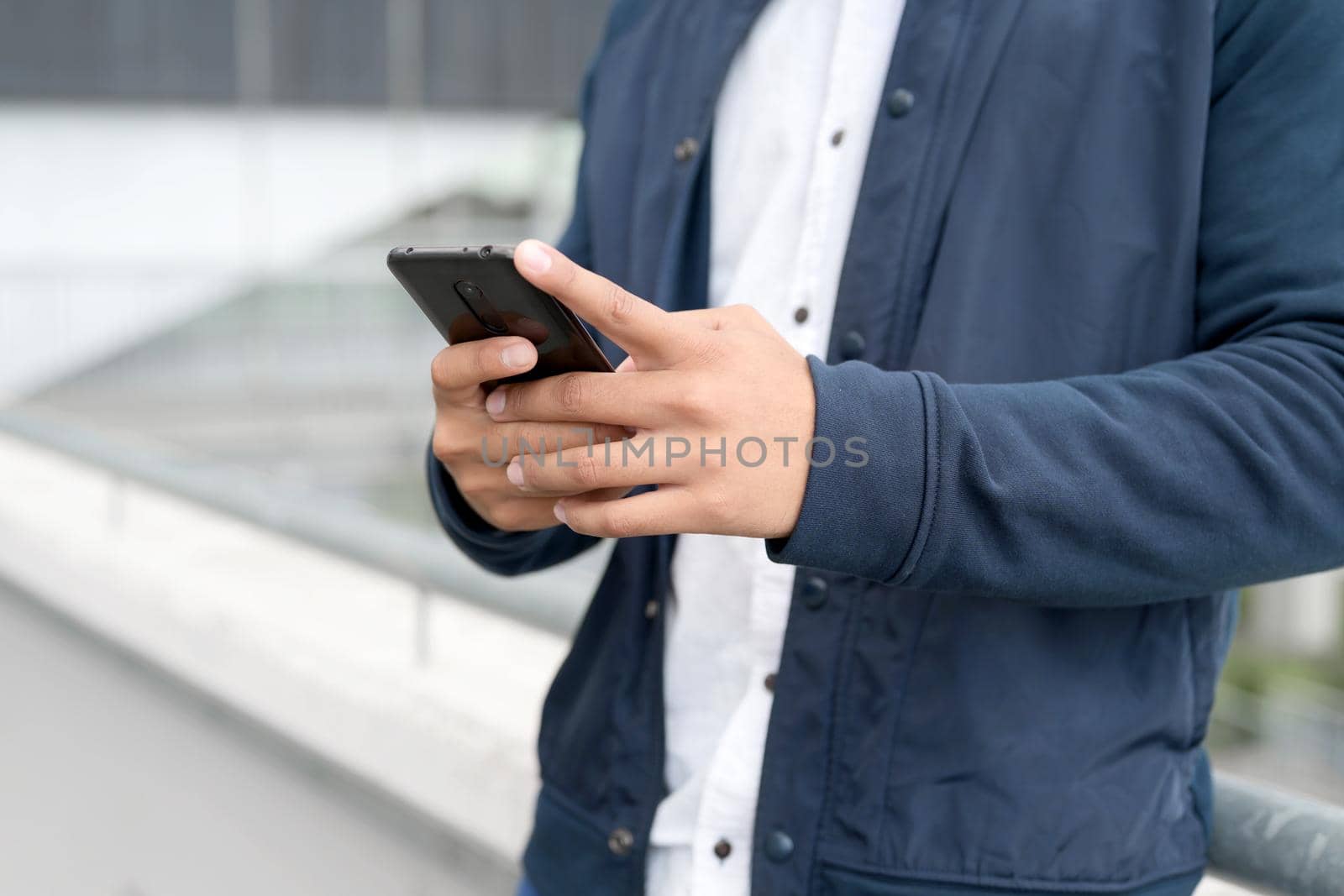 Close up Man texting on cell phone. High quality photo.