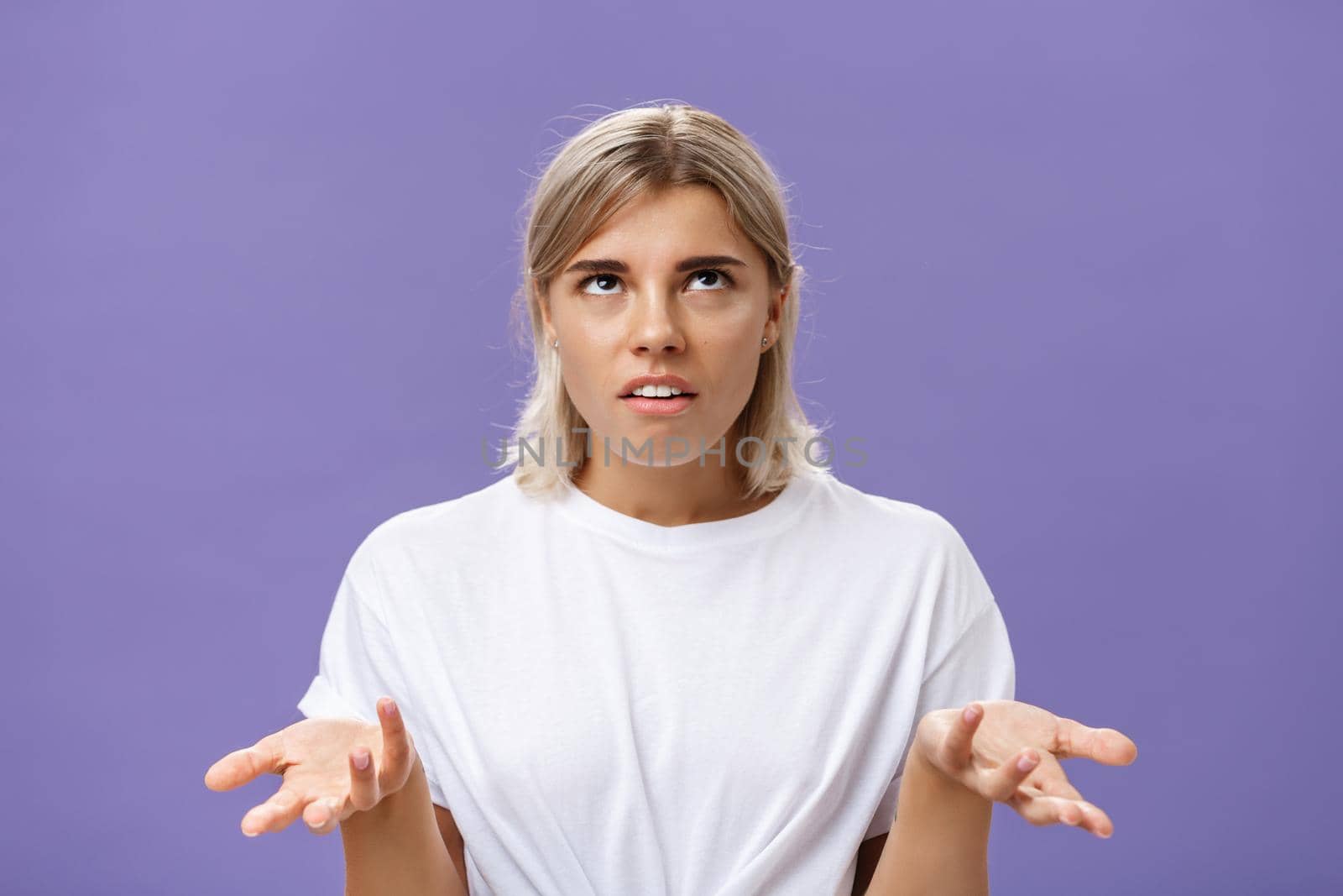 Nah I have no idea. Portrait of irritated bothered good-looking european woman with fair hair rolling eyes up with disappointed expression shrugging with hands raised in clueless gesture by Benzoix