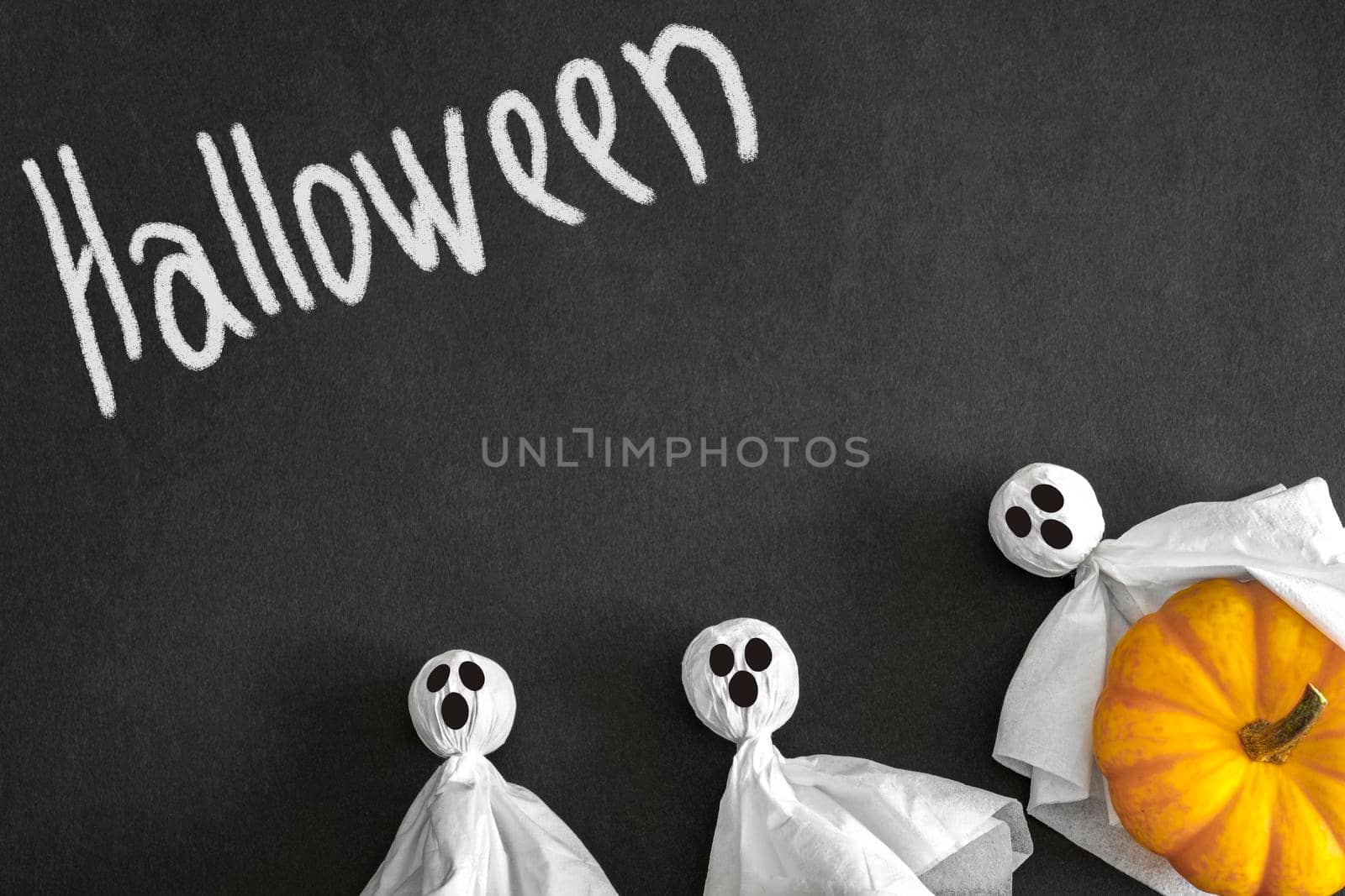 Ghosts, pumpkin, black background, inscription helloween. Top view. Copyspace. by Laguna781