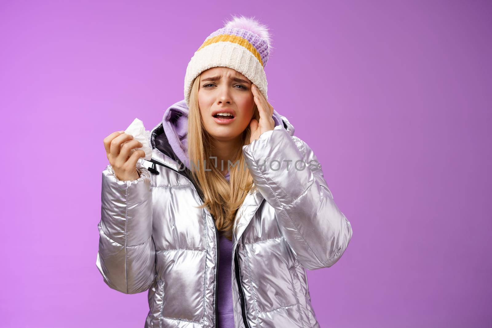 Lifestyle. Ill upset sobbing cute blond girl feel unwell hold napkin tissue touching head temple frowning grimacing painful migraine got sick during winter vacation walking outdoor headache temperature.