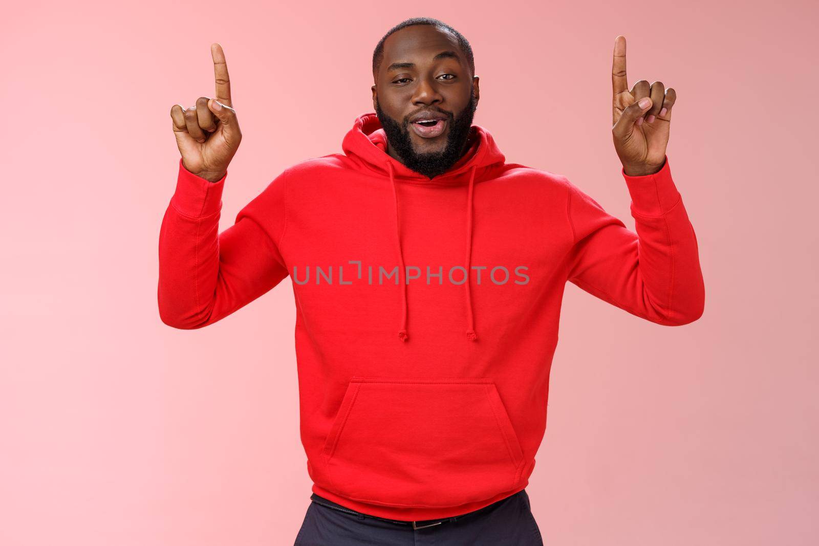 Arrogant young bragging handsome cheeky african-american bearded guy pointing raised index finger up smirking look assertive self-assured, recommending amazing product, pink background by Benzoix
