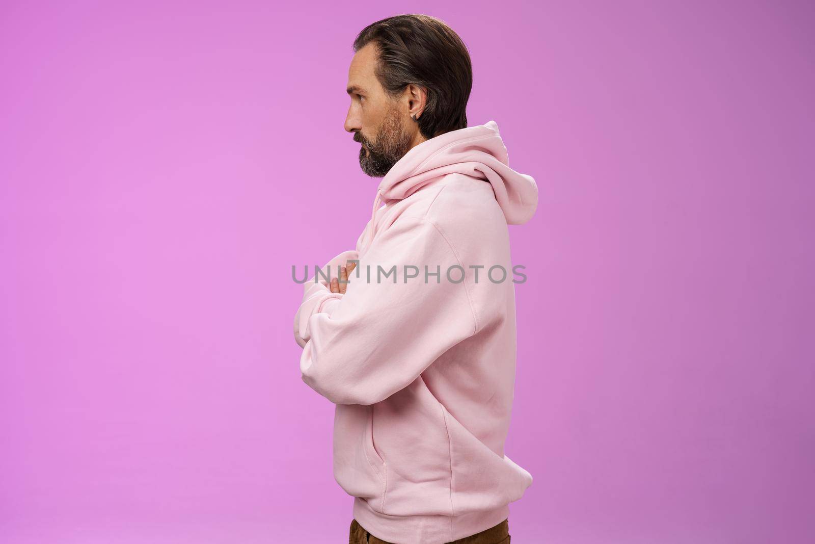 Profile shot serious-looking confident closed defensive adult bearded 40s guy cross arms chest look left impatient irritated standing purple background bothered waiting queue concerned.