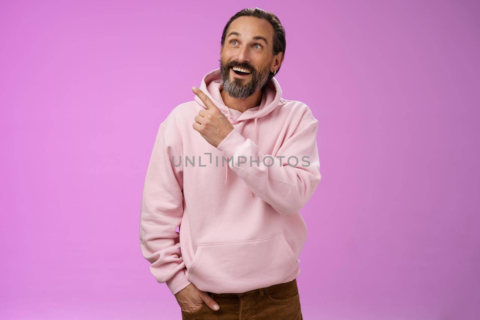 Fascianted joyful handsome mature 40s bearded husband attend interesting amusement park impressed pointing upper left corner enjoying weekend look surprised wondered, gazing alluring product by Benzoix