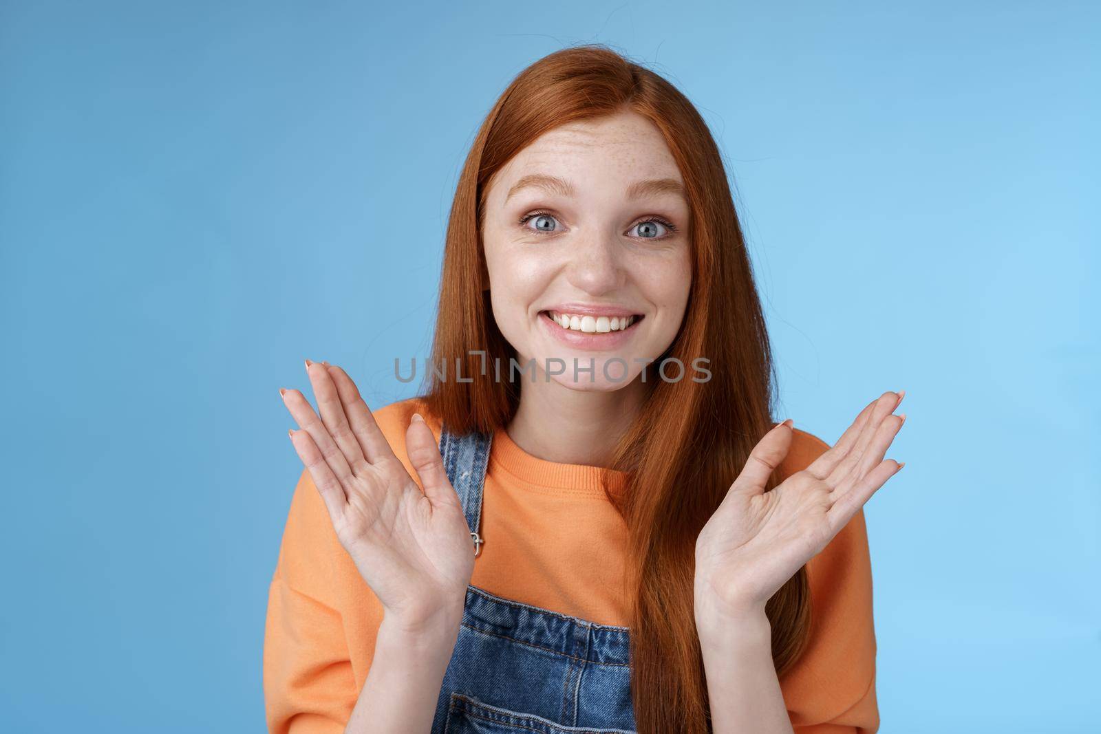 Proud happy supportive young redhead girl friend clapping hands gladly smiling congratulating girlfriend achieve success express happiness cheering attend awesome performance clasping happily by Benzoix