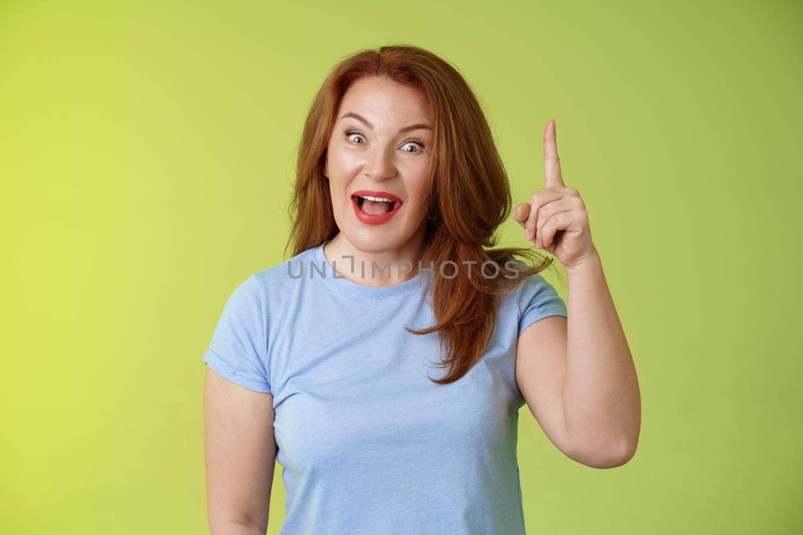 Got excellent idea solution up there. Excited smart creative middle-aged mature woman ginger hair raise index finger eureka pointing top explain offer terms smiling describe cool advertisement.