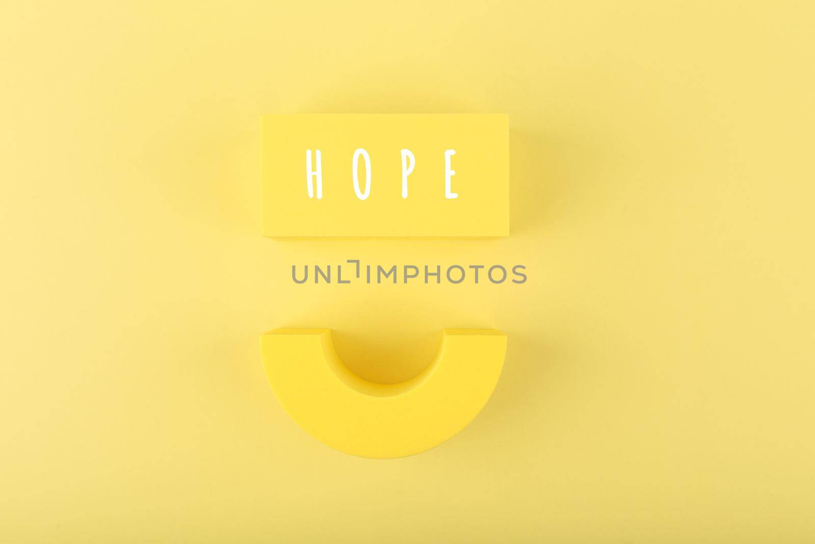 Spiritual optimistic minimal concept of hope with smile against bright yellow background by Senorina_Irina