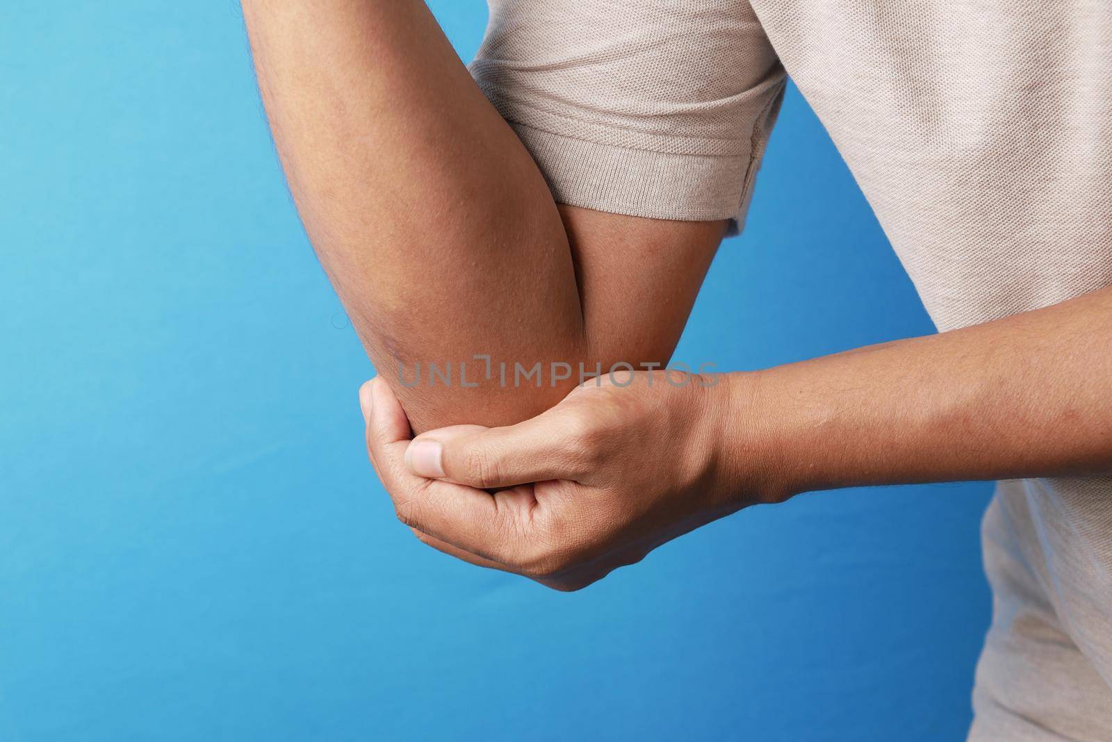 man with elbow pain. Pain relief concept