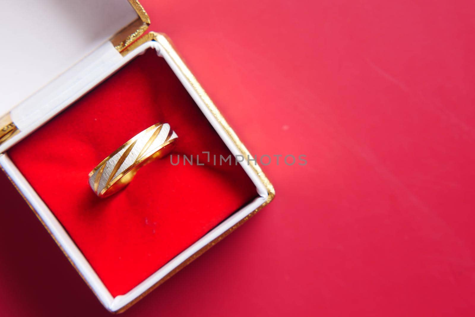 wedding ring in a box on red background , by towfiq007