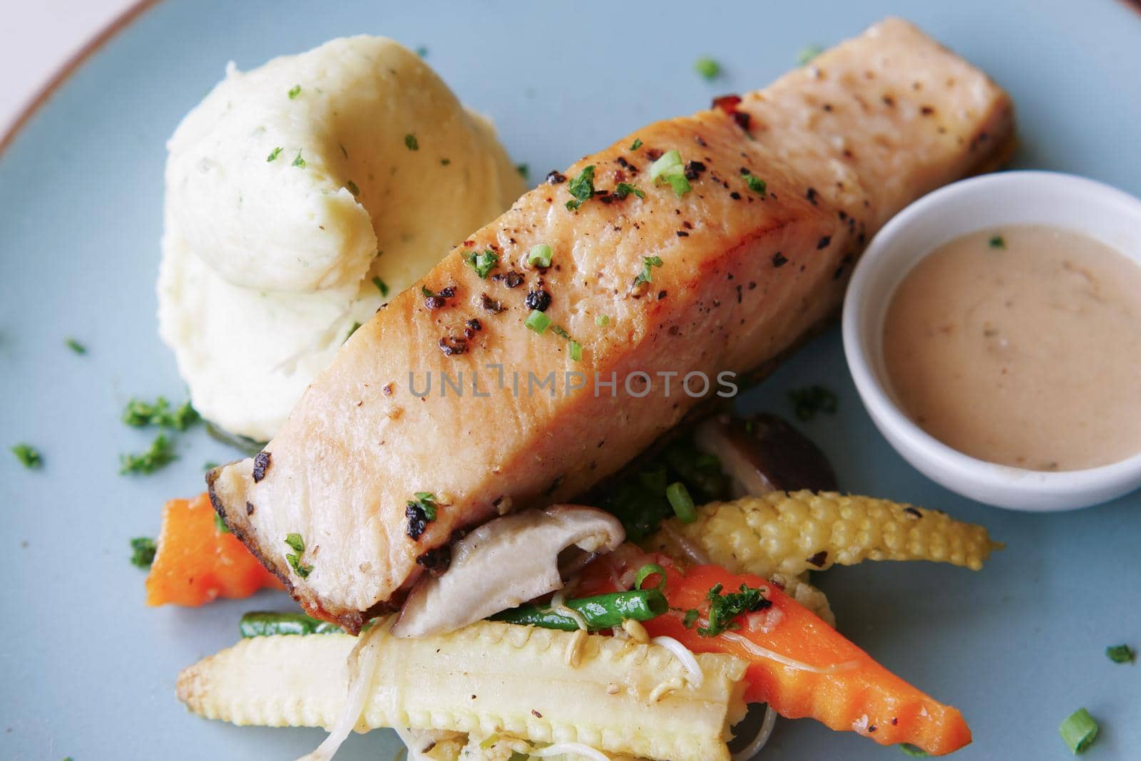 tasty salmon, mash potato and vegetable on plate by towfiq007