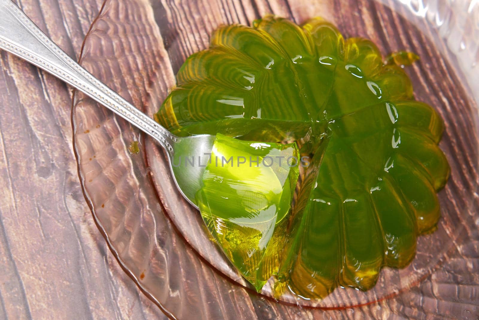 close up of red jelly on plate on table