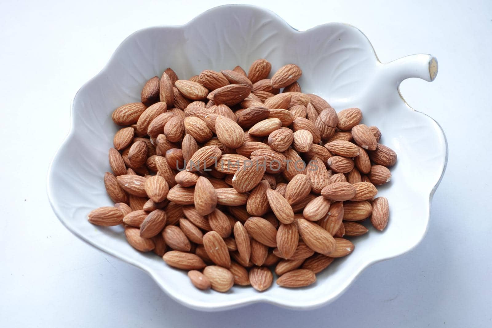 Close up of almond nuts in a bowl .