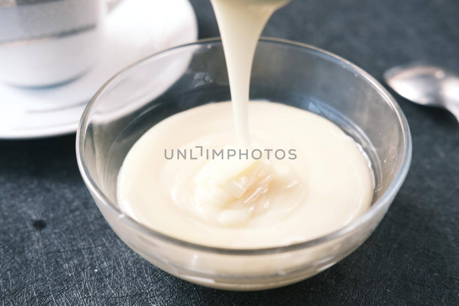 condensed milk in a bowl close up, by towfiq007