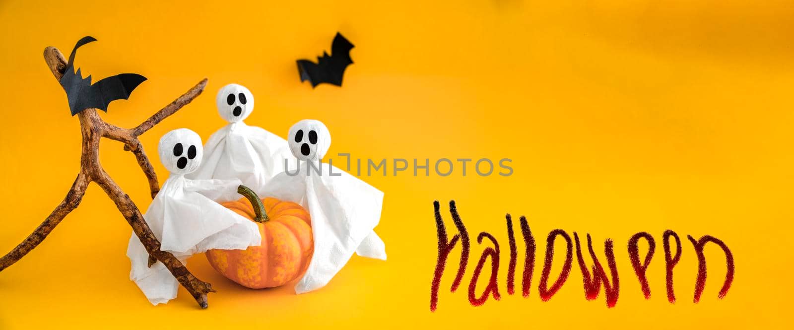 Ghosts, pumpkin, bats on orange background, inscription Halloween. Copy space by Laguna781