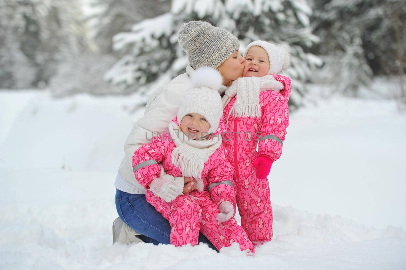 Mom and children on a walk in the winter in the forest by Lobachad