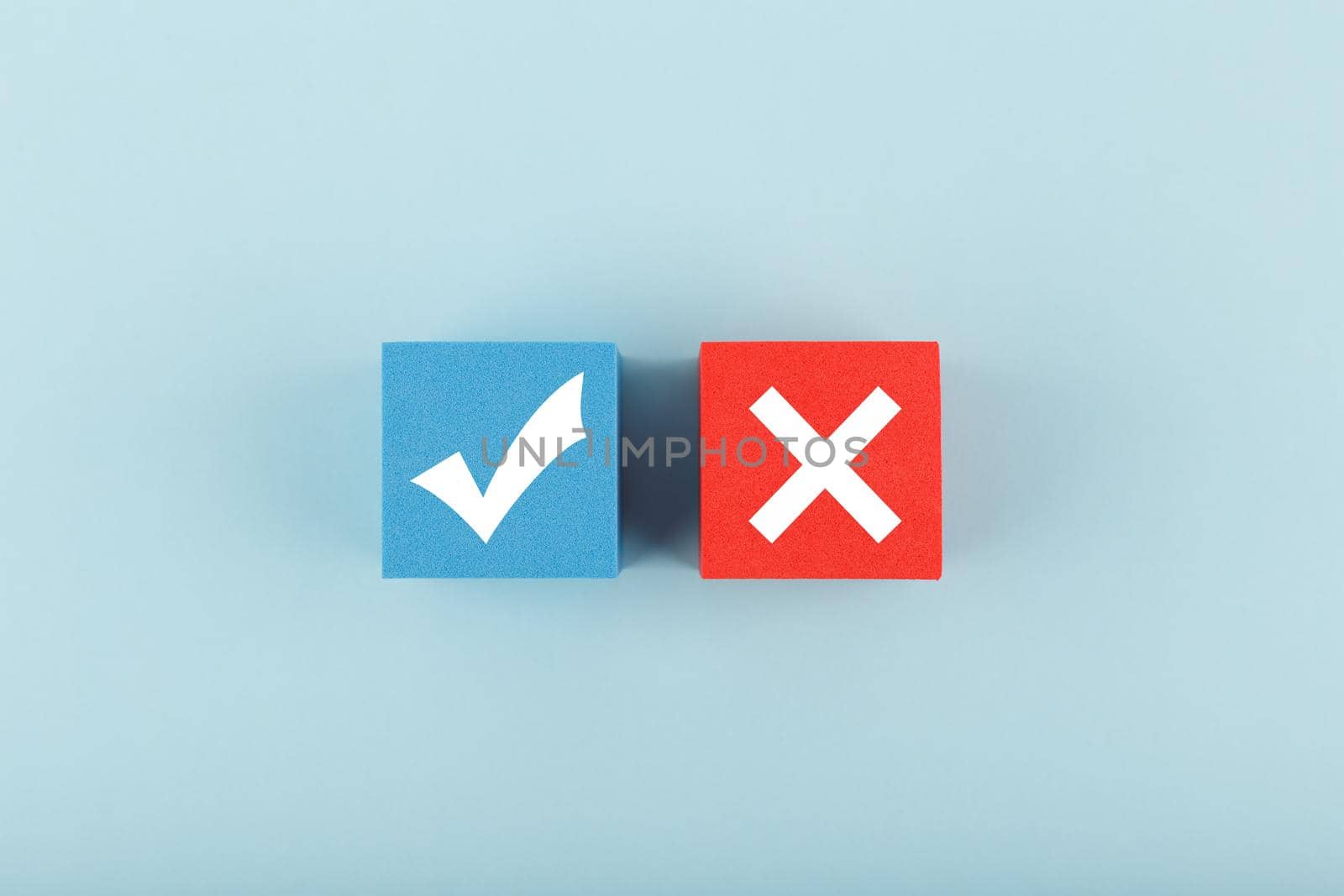 True and false symbol on blue and red cubes against bright pastel blue background. Concept of accept and reject, true or false, right or wrong