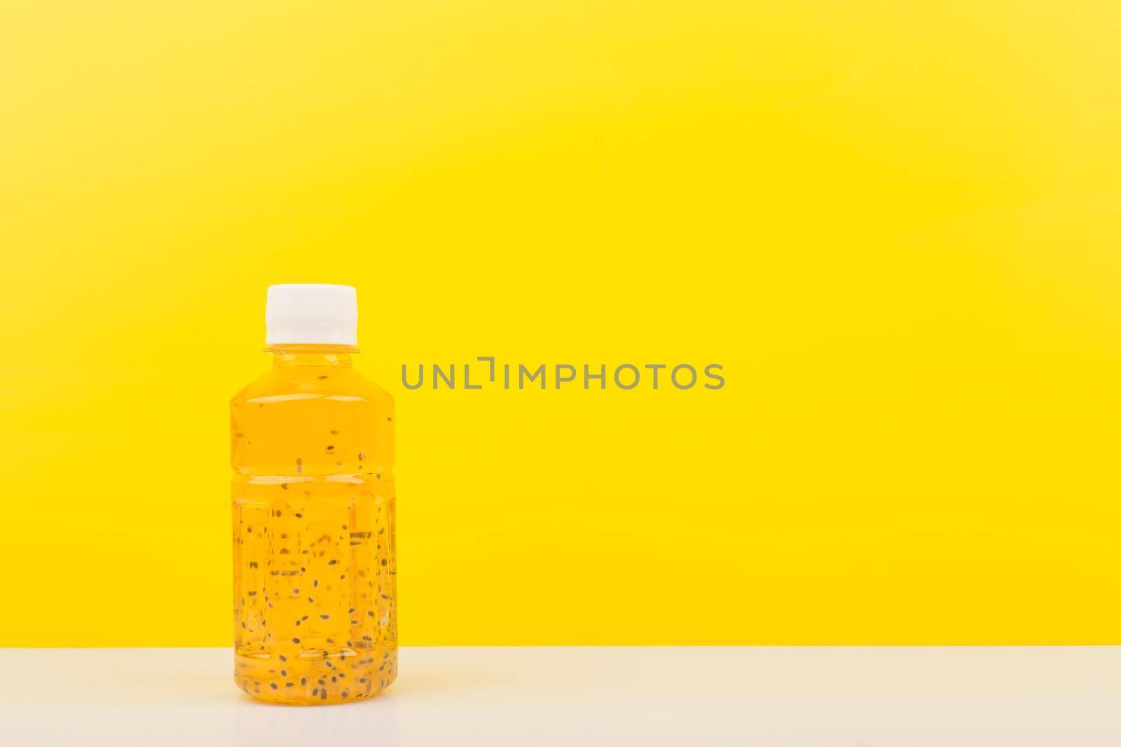 Detox drink or juice with chia seeds on white table against yellow background with copy space by Senorina_Irina