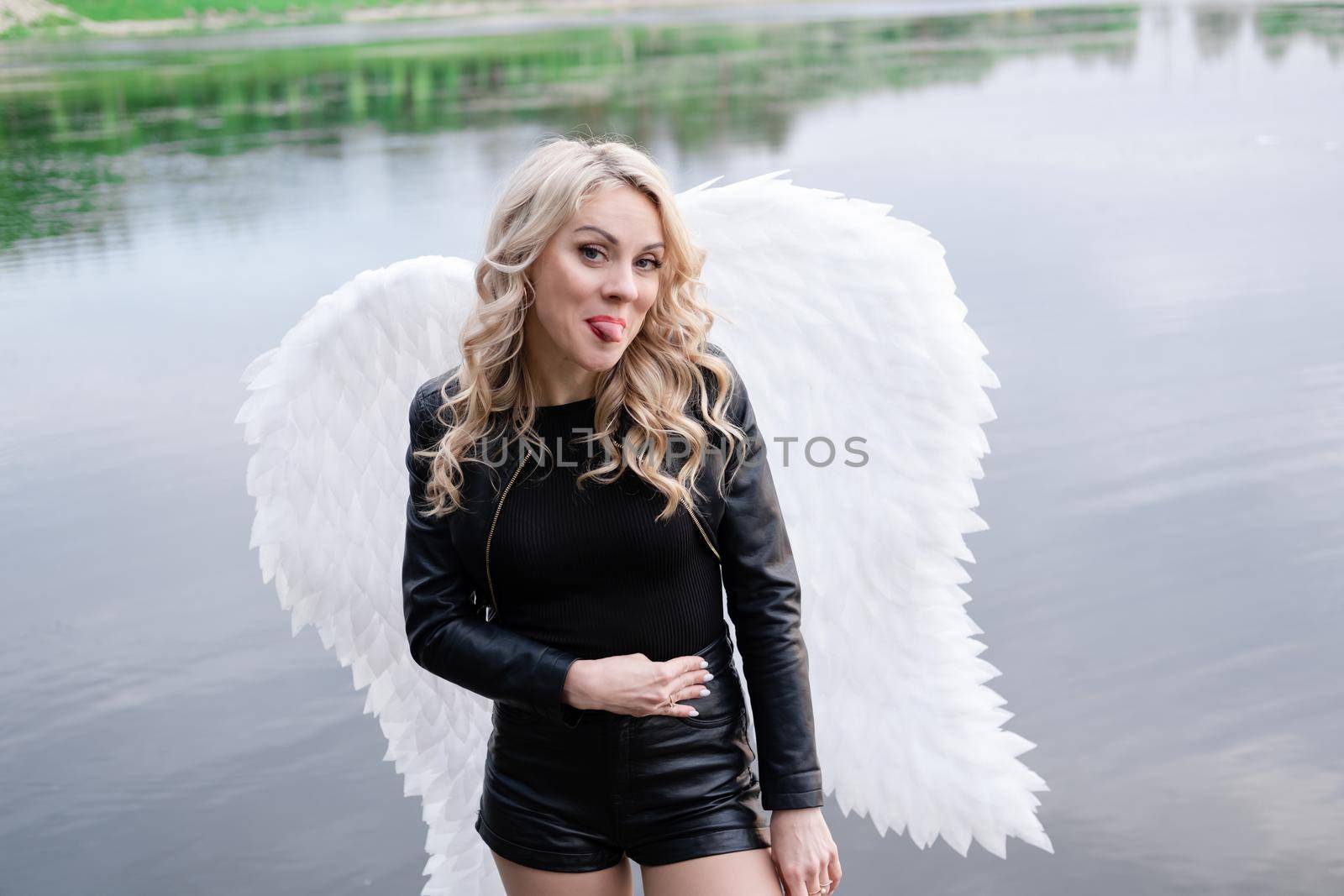 fallen angel. girl in black with white angel wings