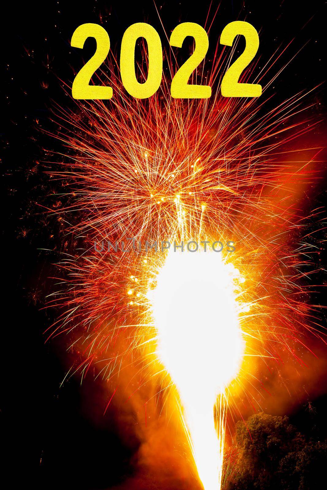 New Years card for 2022 with gold digits on a firework background.