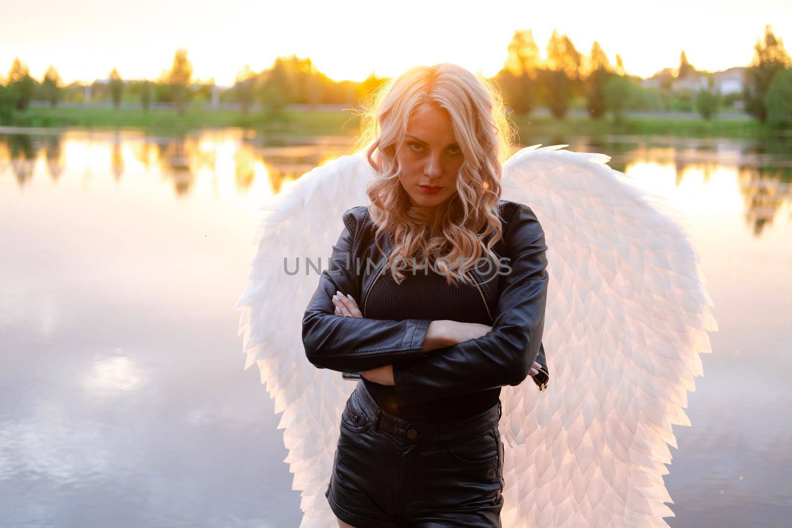 fallen angel. girl in black with white angel wings