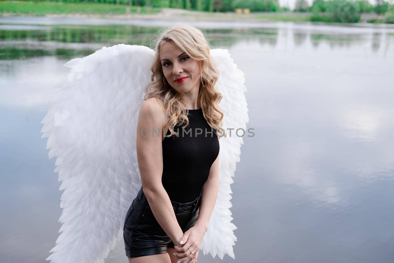 fallen angel. girl in black with white angel wings